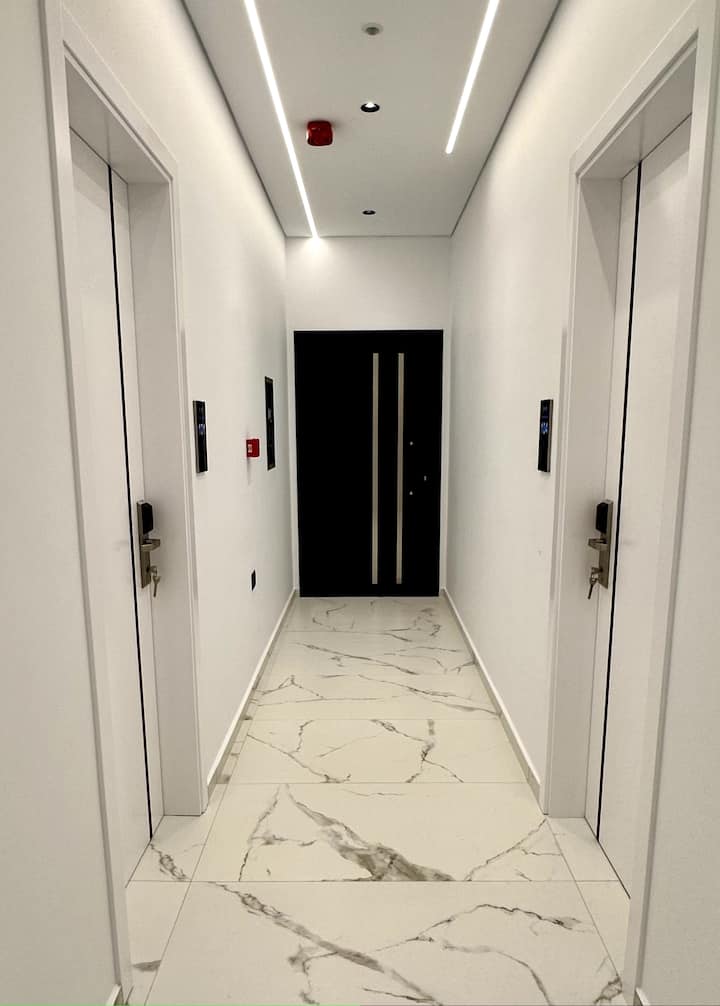 Guest corridor with marble flooring and room doors