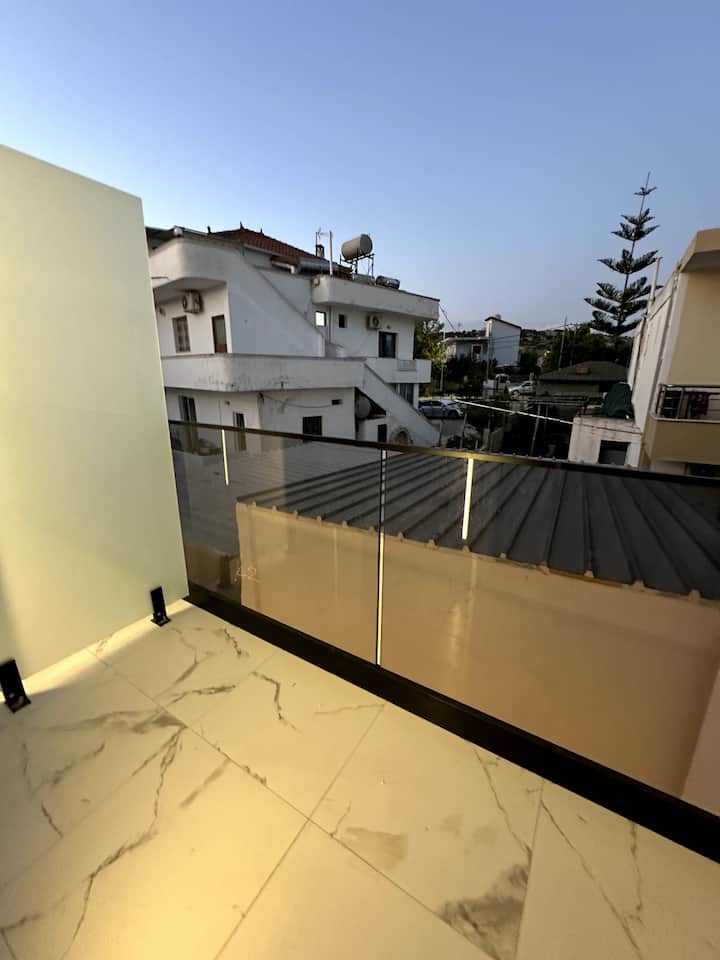 View from a private balcony over Ksamil's rooftops and pines