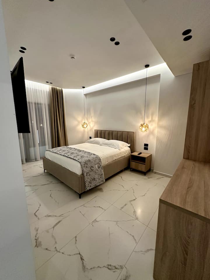 Superior Double Room seen from the entrance, with wardrobe and television